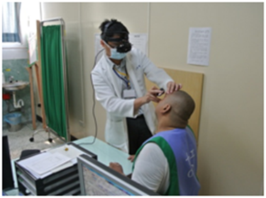 The ophthalmologist is examining the patient